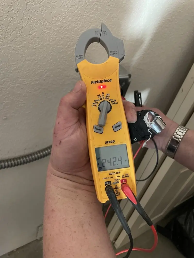 Voltage testing with clamp meter during Outlet Installation in Hilltop